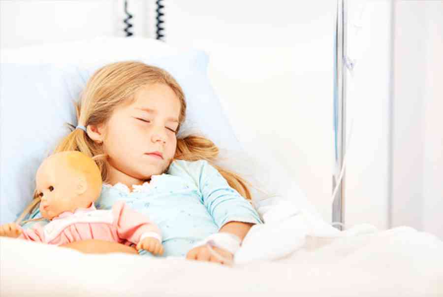 child in hospital with doll